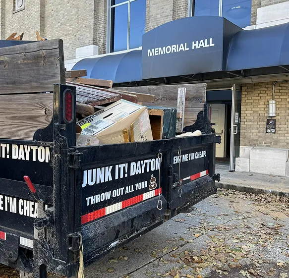JunkIT Dayton team hauling junk from a Dayton, Ohio driveway container